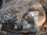 Clear plastic bag of mixed yarn skeins in various colors