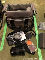 Camera bag with Hasselblad XPan body, zoom lens, filter case and accessories