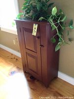 Full front view of the barn red jelly cupboard showing the door and knob.