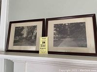 Pair of framed antique photographs showing Maine town streets in black and white, mounted on a white mantelpiece.