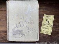 Front cover of the White House Cookbook showing embossed illustrations and title.