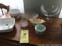 Photo showing full set of vintage vessels on wooden table including porcelain and glass pieces
