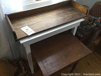 Full view showing the barrister top shelf placed over the small table with drawer. The top shelf has a raised-edge tray design with a worn wood surface, the table has white legs and a wooden drawer front.