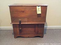 Front view of antique pine washstand showing drawer, cupboard door and wood grain