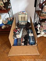 Photo of entire lot with boxed items and visible building on top