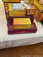 Stack of yellow/orange and maroon Rail King boxes on table