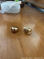 Top view of both 14K gold rings displayed side by side on wood surface