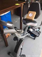 Sunny Health & Fitness exercise bike showing seat, pedals, and frame