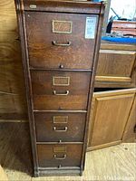 Front view of four-drawer wood filing cabinet