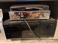 Front view of Crosley turntable on top of Sony CD player CDP-CX200 showing knobs, buttons and display.