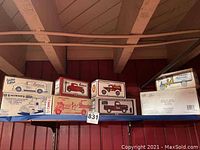 Shelf with multiple Eastwood Transportation Collectables die-cast model cars in original packaging, unopened boxes showing various vintage vehicle illustrations.