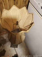 Photo of full fabric lampshade with scalloped top edge and gold trim