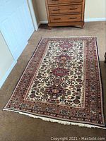 Full view of rug on carpet showing overall design and size