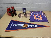 Six-pack of Phoenix Suns themed Coca-Cola glass bottles, Phoenix Suns pennant, koozie, two face masks, and basketball jersey drawstring bag