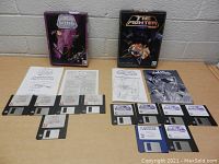 Photo showing boxed X-Wing and TIE Fighter games, manuals, and floppy disks arranged on table.