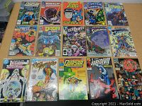 Image shows 16 assorted comic books spread out on a table, front covers visible. Titles include Quasar, RoboCop, Street Fighter, Firestorm, Doom, EleQuest, Superman, Legion of Super-Heroes, Pepito, Daredevil, and Hellblazer.