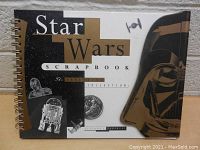 Front cover of Star Wars Scrapbook showing the title and images of Darth Vader, R2-D2, and a TIE fighter.
