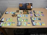 Photo showing two Pokemon Shining Fates Elite Trainer Boxes with a spread of Pokemon cards, dice, damage counters, and deck sleeves laid out on table.