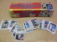 Original 1988 Topps Baseball Cards box with baseball cards spread in front showing player images and team logos, including multiple Dodgers cards.