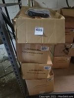 Four cardboard boxes stacked, labeled for belts.
