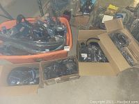 Bins and boxes filled with belts and wallets, all wrapped or in original packaging
