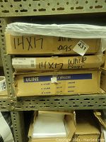 Three stacked boxes labeled ULINE Poly Mailers with plastic mailers on top