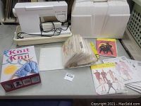 Husqvarna Viking sewing machine in cream carrying case with pedal and cord, vintage sewing patterns in plastic sleeves and loose on table, and Learn to Knit kit box.