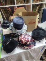 Six vintage ladies hats displayed with Dobbs branded hat boxes in background.