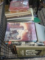 Stack of vintage books in black crate, showing 'Civil War Times' and Winston Churchill books on top