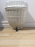 Front view of the white porcelain lava bowl showing basket weave texture and tap