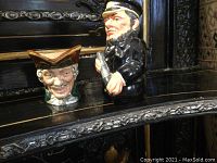 Both Royal Doulton character jugs together, showing Captain Salt on right dressed in black naval attire, about 4 inches tall, and Dick Turpin on left with brown tricorne hat, about 2.5 inches tall.