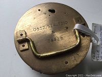 Top view showing the serial number 74429 and stamped numbers 0552/524-7210 on the brass back with attached handle.