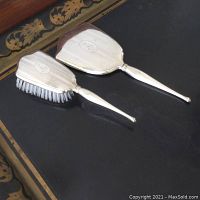 Photo of the pair Birks sterling silver hair brush and mirror with monogram 'A' showing overall condition and style