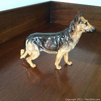 Full side profile of the Royal Doulton German Shepherd dog figurine showing its detailed paintwork and finish.