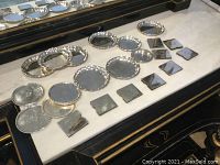 Full group view showing all coasters and napkin clips arranged on a surface