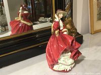 Front and side views of the Royal Doulton Top O' the Hill figurine, showing detailed painting, posture, and colors.