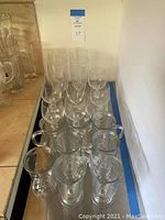 Photo showing 5 Marquis Waterford wine glasses, 4 smaller wine glasses, and 5 Irish coffee mugs grouped on shelf