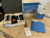 Full box opened showing the Ring Video Doorbell Pro unit, multiple interchangeable faceplates, and mounting hardware inside the packaging.