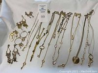 Front view of all jewelry items laid out including necklaces and earrings on white background.