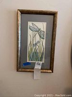 Framed dragonfly print with metallic frame and gray mat, showing dragonflies flying over grass.