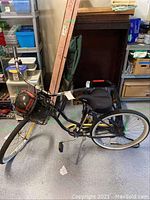 Side view of Raleigh women's beach cruiser bicycle with basket holding a helmet.