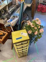 Metal crackle painted cabinet with seven drawers and faux flowered metal plant stand