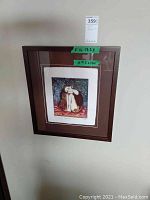 Framed print hanging on a wall showing the artwork and measurements of the frame and art.