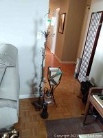 Photo showing both the tall vintage metal floor lamp and smaller desk lamp standing side by side in a room with hardwood floor.