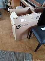 Closed HP desktop computer box showing HP branding, confirming presence of HP desktop.
