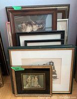 Multiple vintage framed prints stacked together showing size and frame details