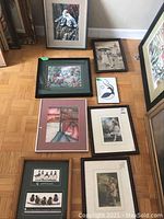 Overview of all 8 framed prints and pictures arranged on the floor