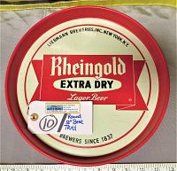 Top down photo showing front of round 12" Rheingold Extra Dry Lager Beer advertising metal tray with red border and cream background, measuring 12 inches across as shown against ruler.