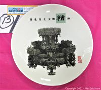 Top view of white round plate showing detailed black print of ancient Chinese bronze Zun vessel with dragon beast motifs and Chinese characters.