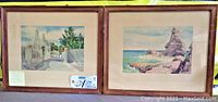 Both framed watercolor paintings by Adolf Treidler together, showing scenes from Bermuda in wooden frames with beige mats.